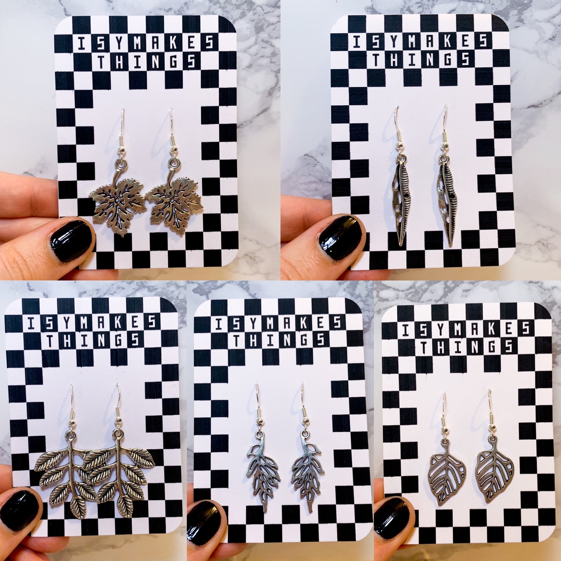 Silver leaf dangle earrings on a black and white checkered backing card with the title isymakesthings