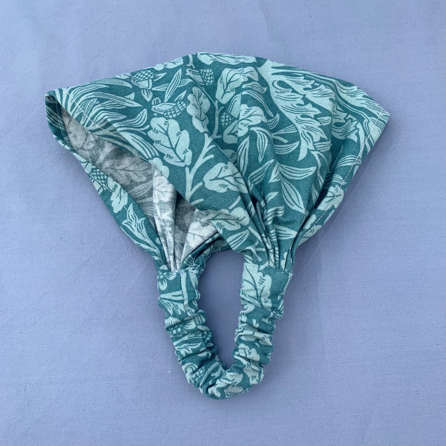 a folded blue floral bandana on a blue background