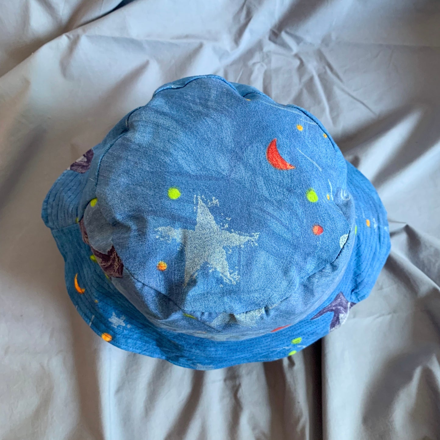 The top view of a blue bucket with stars, on a blue background