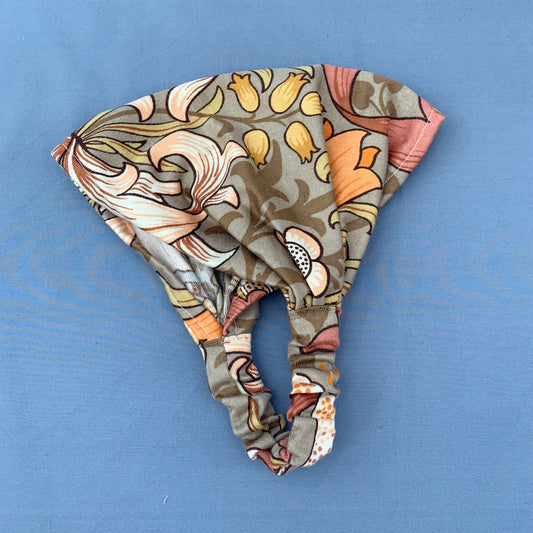 a folded brown floral bandana on a blue background