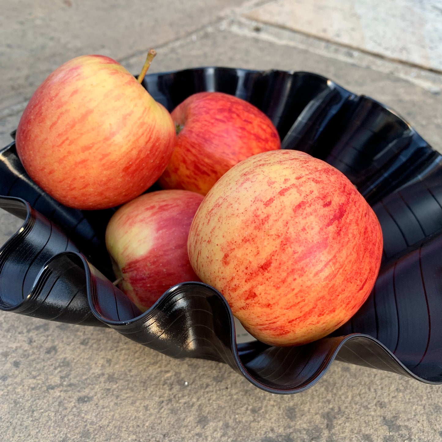 A wavy vinyl record bowl filled with apples